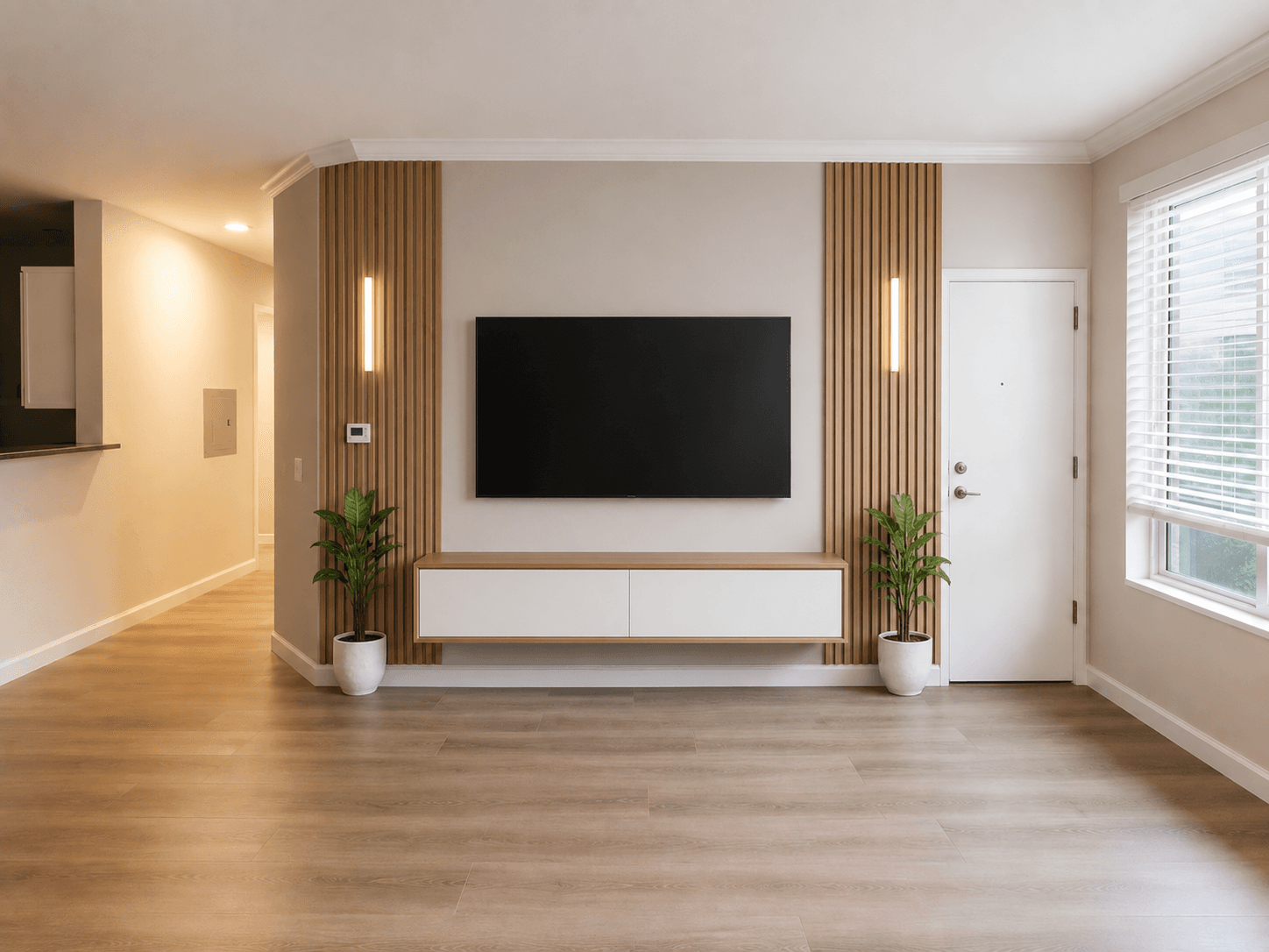 Oak slat media wall with floating white credenza and lit sconces in a San Jose living room